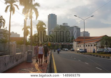 George Town, Penang, Malaysia - April 18, 2016: tourist at a city street in , Georg , dusk with light trails and traffic sign, Georgetown.