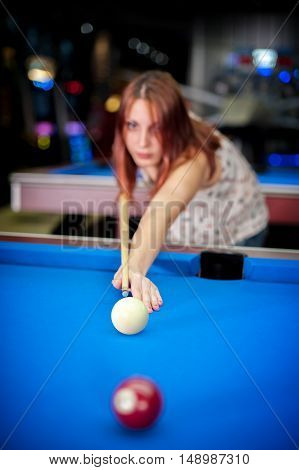 Young Woman Playing Pool Game In Pub