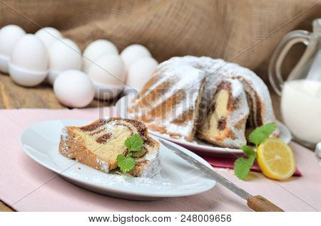 Cut Of Marble Cake Sprinkled With Sugar, Milk, Eggs, Melissa And Leaves, , Still Life With Marble Ca