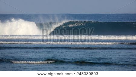 A Powerful Wave Breaks On The Reef In Sumatra Indonesia. Waves Like This Are Favourite Of Surfers Wh
