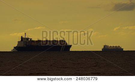 Oil Tanker Ships At Sea On A Background Of Sunset Sky In Sipitang,sabah Borneo,malaysia.