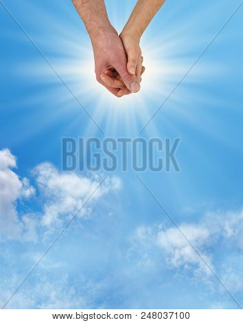 That Heady Feeling Of Being Loved Up - Male Hand Holding Female Hand With A Bright Sun Behind On A B