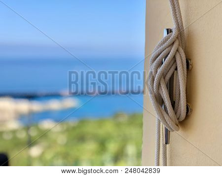 Metal rope tie bracket on a wall at a villa