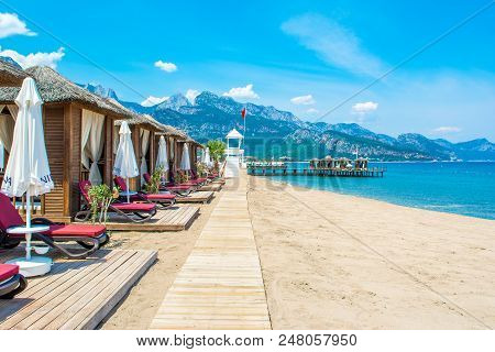 Antalya, Turkey - 9 May 2018: Wooden Beach Pavilions On The Shore Of A Sandy Beach - The Mediterrane