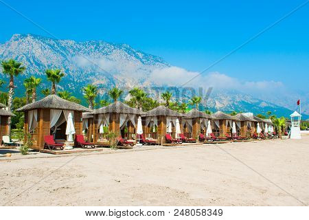 Antalya, Turkey - 10 May 2018: Wooden Beach Pavilions On The Shore Of A Sandy Beach - The Mediterran