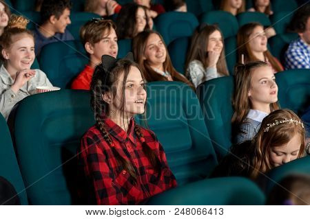 Beautiful Young Girl Watching Film With Steadfast Eyes And Smiling, Expressing Facial Emotions. Yout