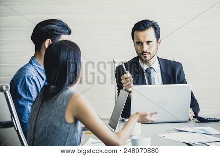 Young Business People Working Together With Serious Emotion. Business People Takling In Modern Offic