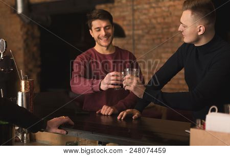 Friendly Talk In Bar. Top View Of Two Happy Young Men Talking To Each Other And Enjoying Whiskey, Ch