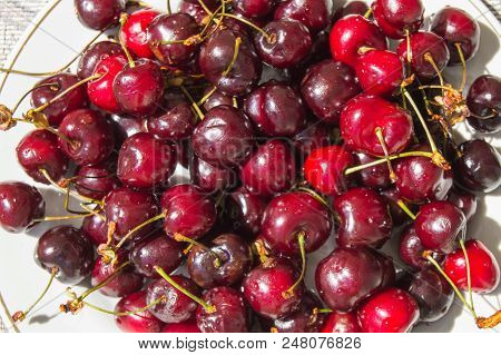 Fresh Ripe Cherry On A Plate, Top View.