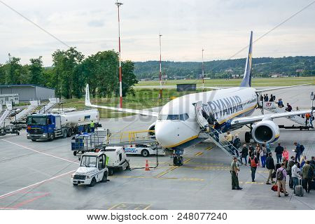 Krakow, Poland - June 25, 2018: Travelers Boarding Ryanair Boeing 737 In Krakow Balice Airport. Ryan