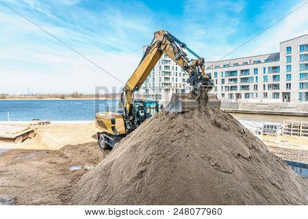 Excavator In Construction Site. Buildingindustry And New Building Concept