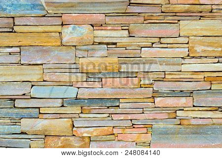 Decorative Stone Wall, Pieces Of Rock Bonded With Cement. Cobble Texture With Cracks. Mountain Of Ca