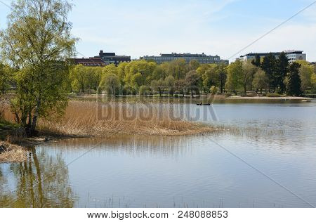 Helsinki, Finland - May 13, 2018: People Row A Boat On Toolo Bay In The City Park In Helsinki. Scand