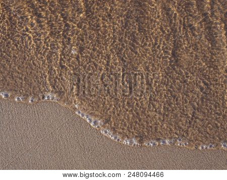 Sandy Shore Of The Lake. Small Waves