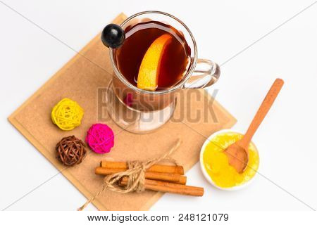 Glass With Mulled Wine Or Hot Tea With Grape, Cinnamon And Honey On White Background, Top View. Glas