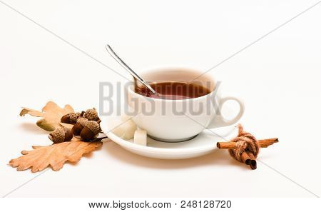 Autumn Drink Concept. Drink And Acorn And Oak Leaves. Mug Filled With Black Brewed Tea, Spoon And Au