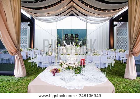 A Wide Angle View Of A Wedding Reception Venue, With Dance Floor And Surrounding Tables. A Large Cha