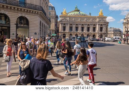 Paris, France - 25 June 2018: A Crowd Of People Crossing Rue De La Paix Near Paris Opera Garnier.