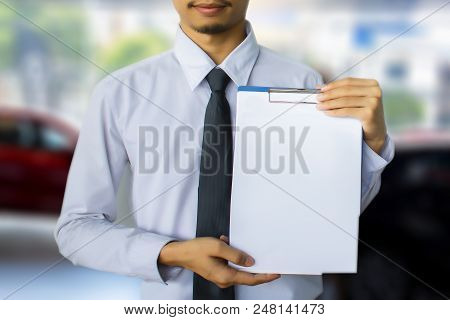This Career Man Saleman Business Inspection Writing On Notepad Or Book,
Paper With Car Blurry Backgr