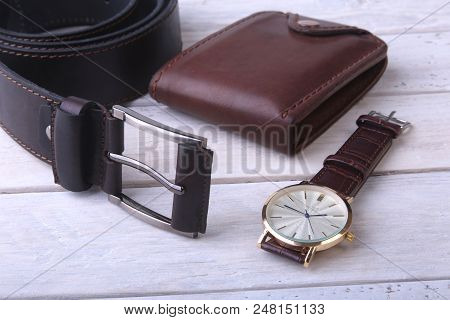 Men's Accessories For Business And Rekreation. Leather Belt, Wallet, Watch And Smoking Pipe On Wood 