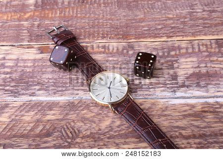 Men's Accessories For Business And Rekreation. Watch And Dice On Wood Background.. Top View Composit