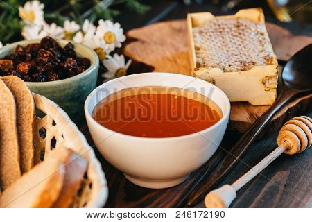 Honey In White Ceramic Bowl, Honey Dripper Spoon, Homemade Honeycomb On Rustic Wooden Table, Close U