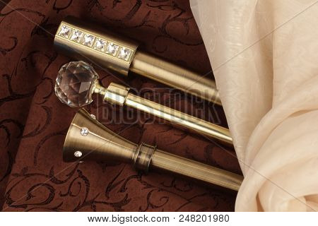 Metal ending for cornices and the folded fabric. Curtain rod and finials on the folded fabric