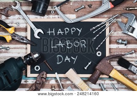 Chalk Board With Text Happy Labor Day With Variety Gruge Rusty Handy Tools On A Rusty Wooden Table.
