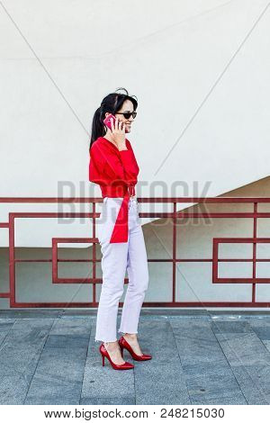 Fancy Young Woman Standing On A Street, Wearing Stylish Red Blouse And Red Highheel Shoes In Black S