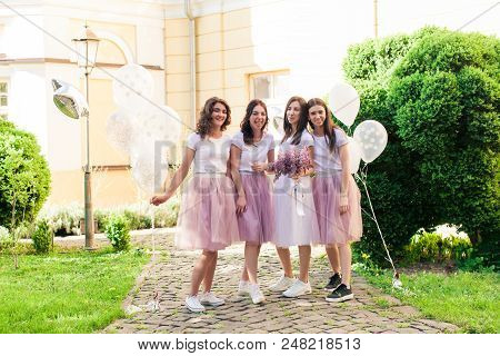 Happy Lovely Girlfriends In Pink Tulle Skirts Having Fun At Hen Party Outdoors