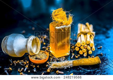 Close Up Of Effective Home Remedy For Toothache Or Tooth Sensitivity Or Erosion: Clove Oil With Blac