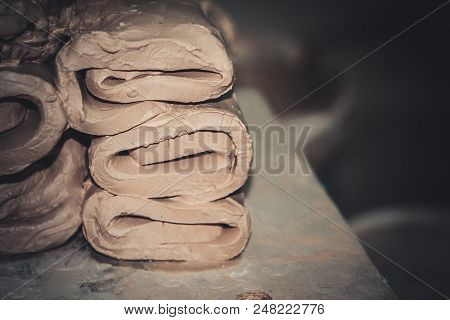 Wet White Clay Closeup. Abstract Pieces Of Wet Clay On The Table. Sculptor Sculpts Pots Products Fro
