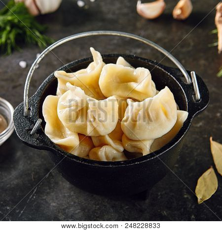 Dumplings Jiaozi, Dimsum, Momo or Ha Gao on Dark Background. Asian Food of Dough Based on Flour Stuffed with Meat, Fish, Vegetables, or Sweets