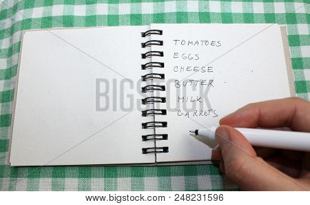 Hand With A Pen Writing A Shopping Food List Notes Checklist
