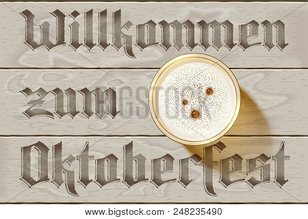 Glass Of Beer On Wooden Background With German Inscription Willkommen Zum Oktoberfest. Top View On B