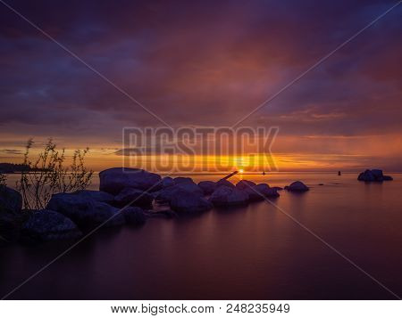 Impressive Dawn On The Lake. Stones In The Water.