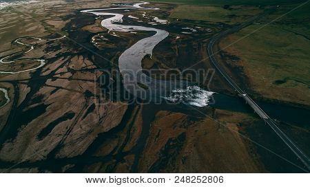Aerial View Of River In Black Sand With Many Junctions