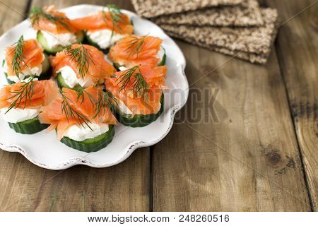 Cucumber And Salmon, Small Snacks On A Plate. Copy Space.