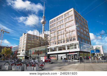BERLIN GERMANY - OCT 30, 2016: People near fountain on Alexanderplatz square in Berlin city on Oct 30, 2016. Germany. Alexanderplatz is large public square and transport hub in central Mitte district