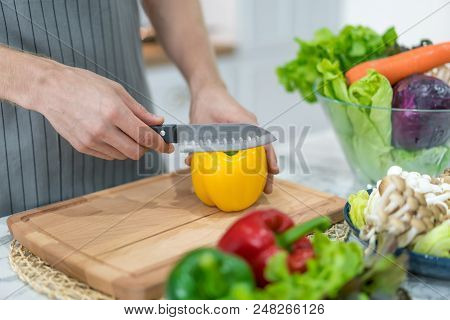 Cooking Process. Yellow Bell Peppers. Person Chopping Red Bell Peppers. Stuffed Bell Peppers Recipe.