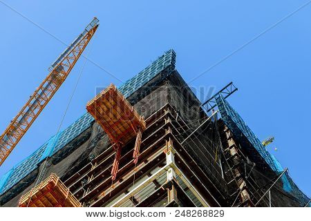 Construction Site With High-rise Crane Supplies Material To A High-rise Buildingtwo Cranes