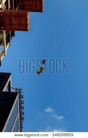 Urban Construction In High-rise Crane Supplies Material To A High-rise Building