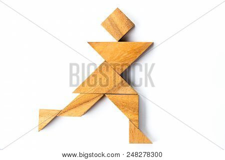 Wood Tangram Puzzle In Man Running Shape On White Background