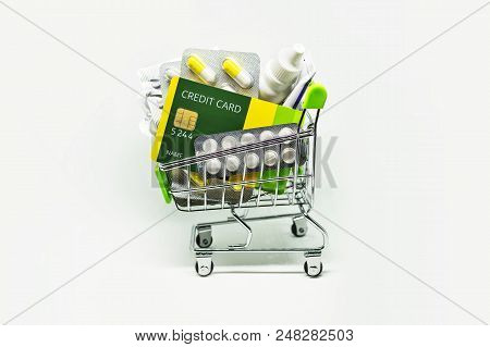 Many Medicines And Making Purchases, Paying With A Credit Card. Basket Of Pills Ointments And Other 