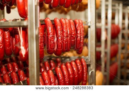 Sausage Workshop.stick Of Sausage Are Smoked On The Background Of The Meat Factory