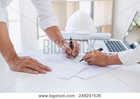 Architect Or Engineer Meeting Working With Partner On Blueprint For Architectural Project In Progres