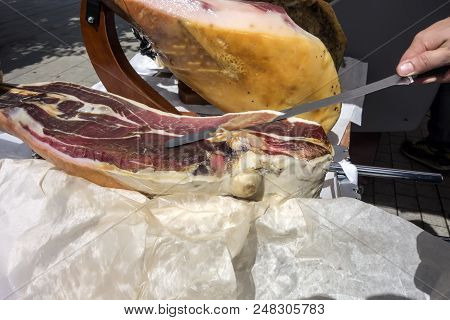 Prosciutto. Traditional Spanish Ham On Close Up. Slicing Hamon Iberic. Waiter Is Slicing Jamon Prosc