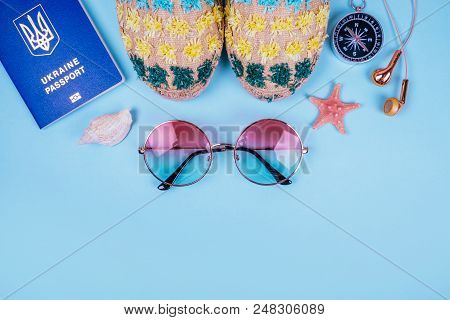 Travel Flatlay With Biometric Passport, Gradient Round Sunglasses, Earphones, Compass And Espadrille