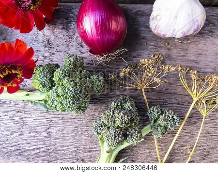 Vegetables  From Organic Grower Farm On A Wooden Background.garlic, Onion And Broccoli.top View. Pla