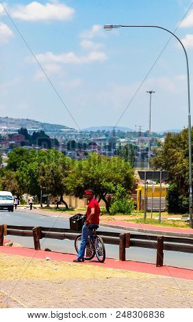Johannesburg, South Africa, November 16, 2012, African Man On A Bicycle Tour Of Soweto
